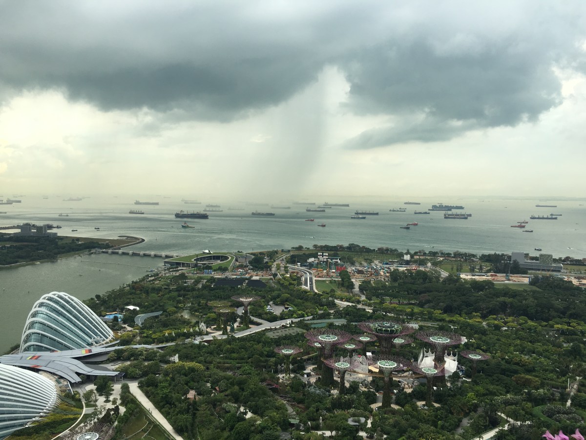 Rainstorm over Ships in Singapore Harbor